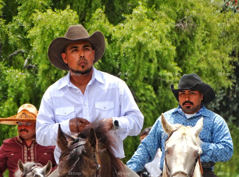 Latino Cowboys. Handsome Cowboys Riding Trained Horses
