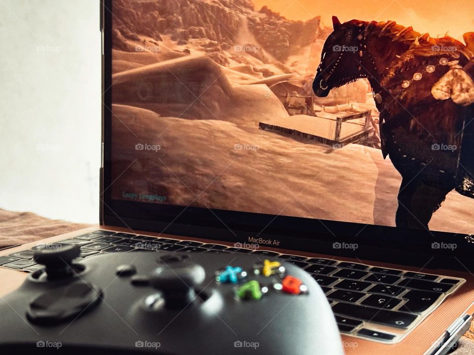 Skyrim Videogame played with a black Xbox controller in a laptop.