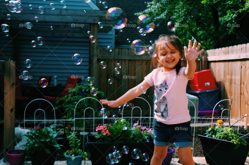 Happy girl dancing in bubble