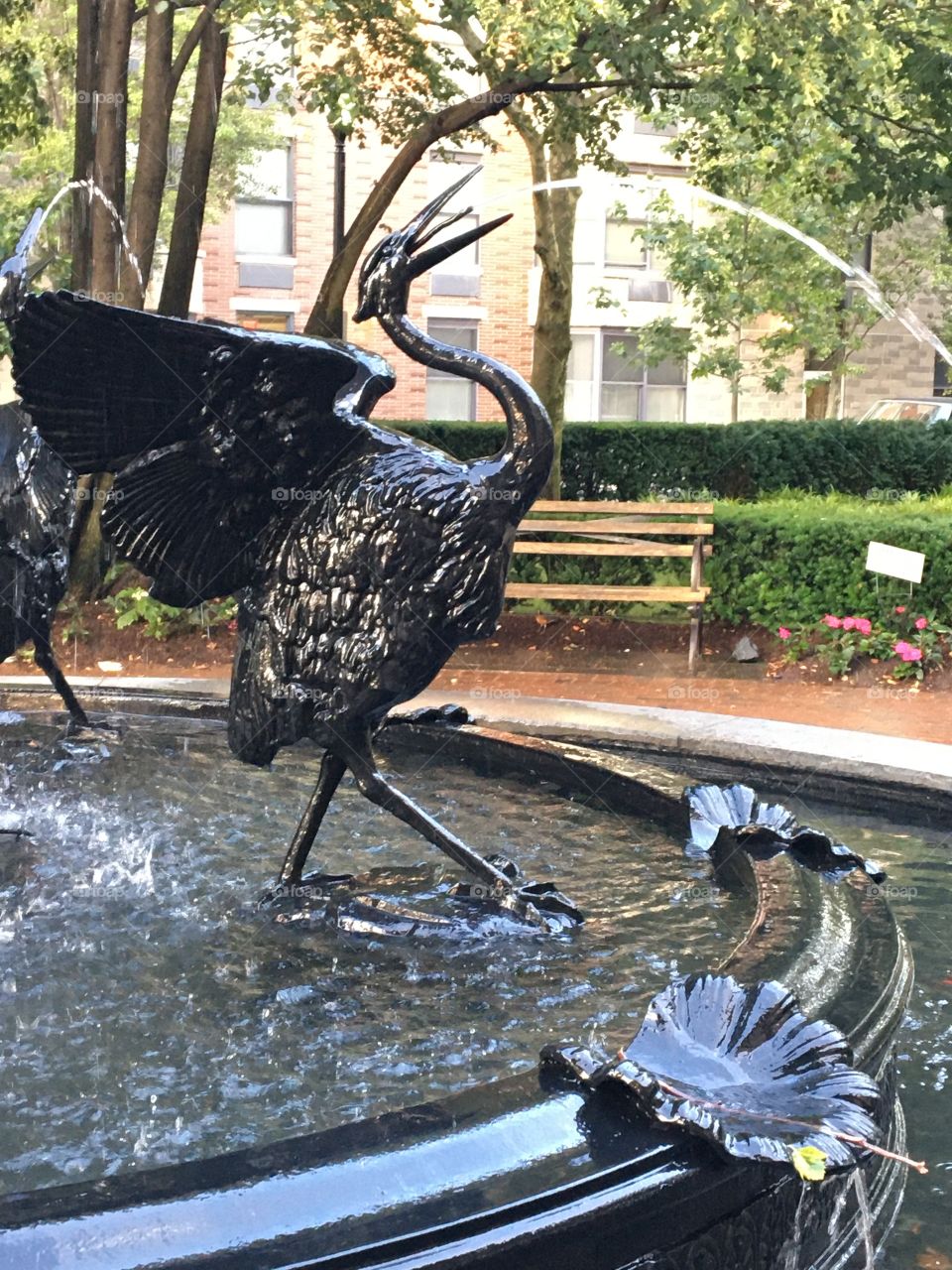 Crane fountain spouting water