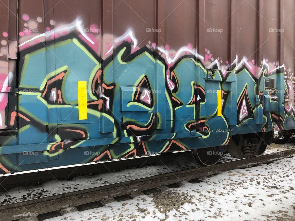 Bold and bright graffiti on train cars. Caught me eye while I was on a job in a CN Rail Yard. 