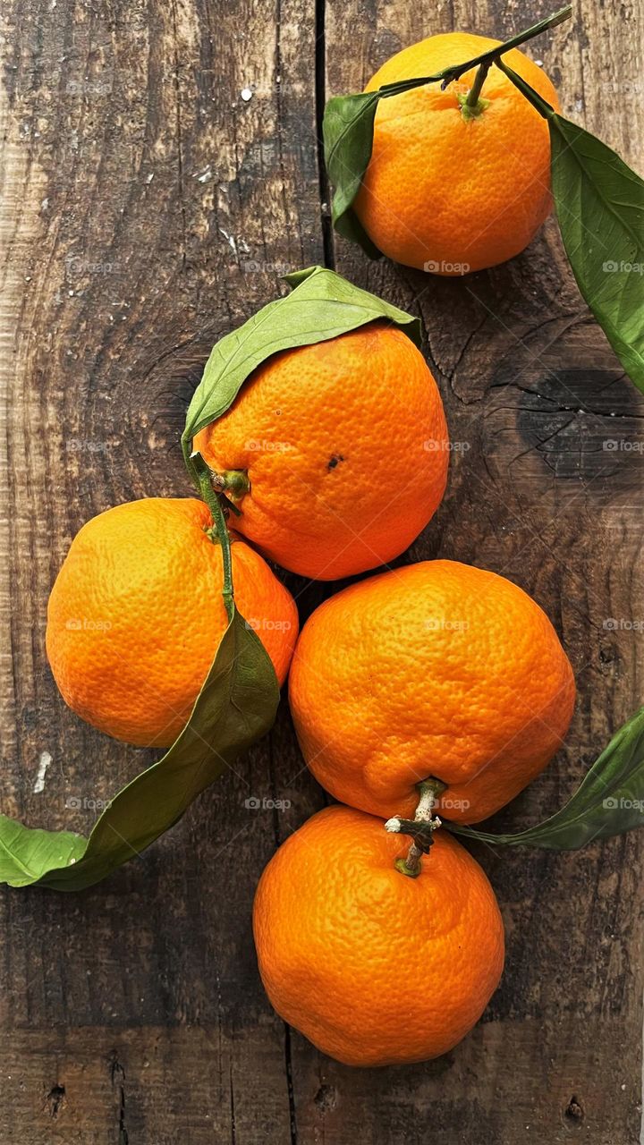 Juicy orange ripe tangerines in the rays of the southern sun.