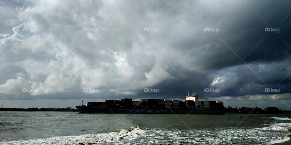 Ship carrying containers beginning it's journey