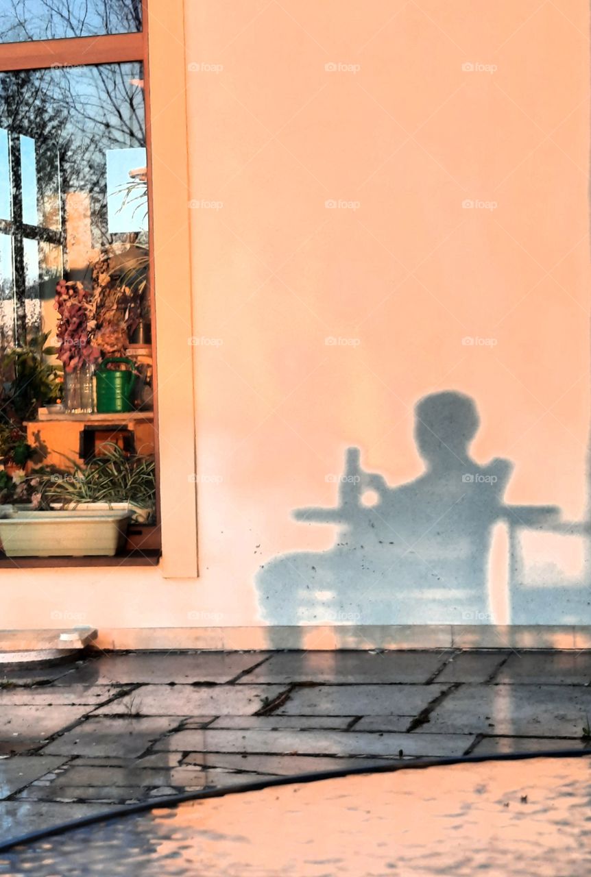 shadows of a person sitting at the table