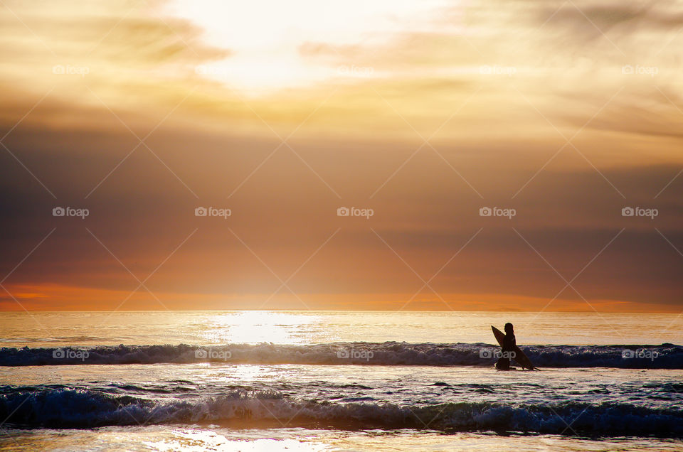 Sunset and surfer