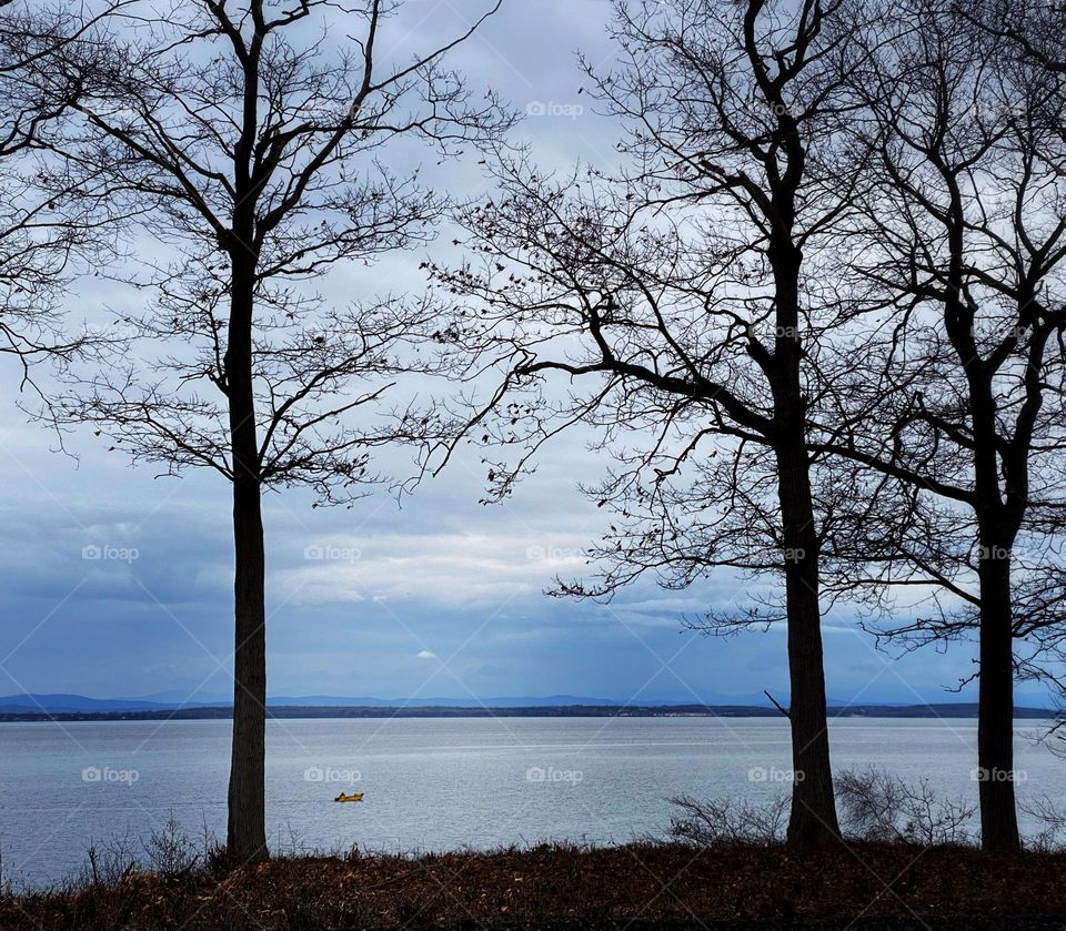 Small boat on Lake Champlain in early spring 