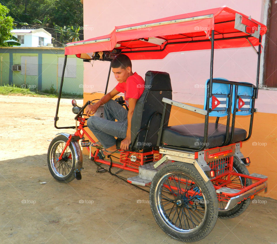 BC Taxi . This young Cuban man awaits customers to transport throughout Santiago,Cuba. He has a built in stero and a sun roof. 