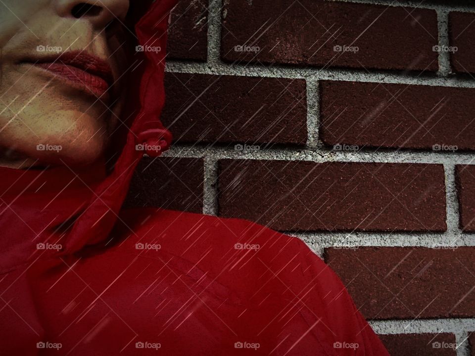 Woman in a red raincoat in the rain.