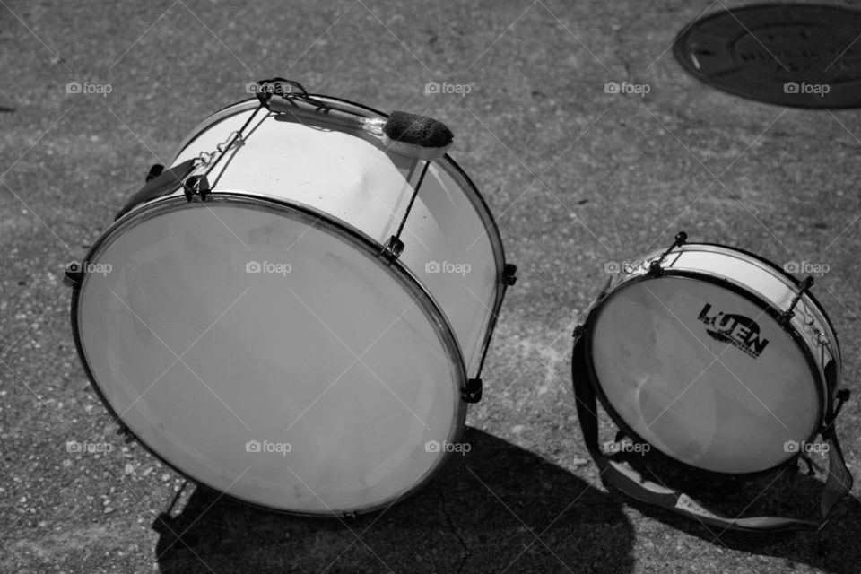two little hand drums in the floor white in colour