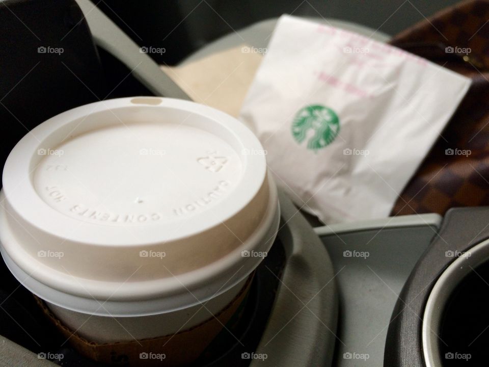 Breakfast on the go. Starbucks latte and a pastry on the way to work