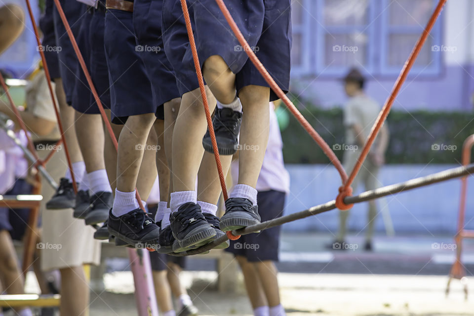 Children walking on the wire rope are doing the activity.