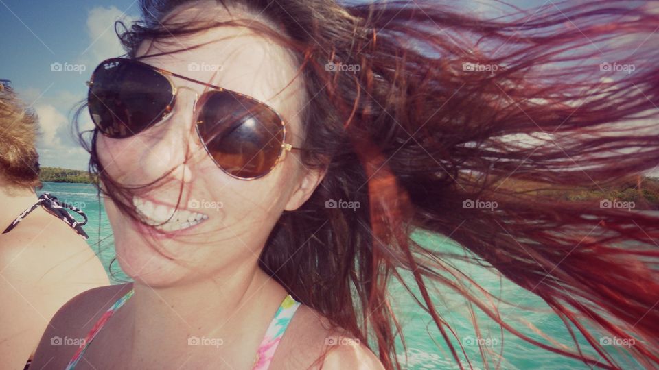 Smiling woman with long hair blowing in wind