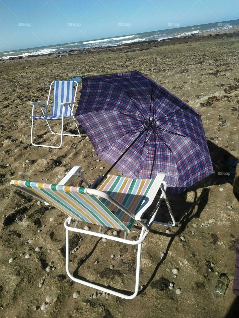 My chairs and umbrella in the beach near the sea at essaouira in Morocco