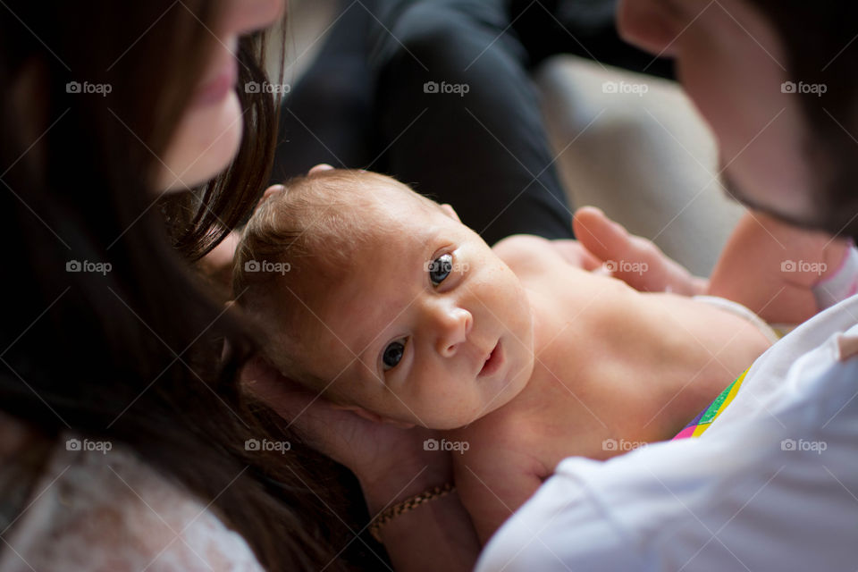 Father carrying his newborn baby