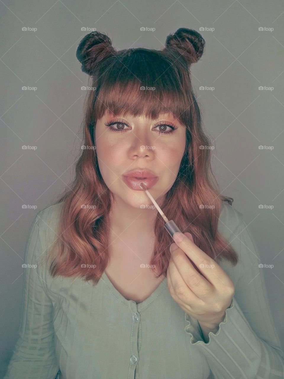 Portrait of a woman putting on makeup