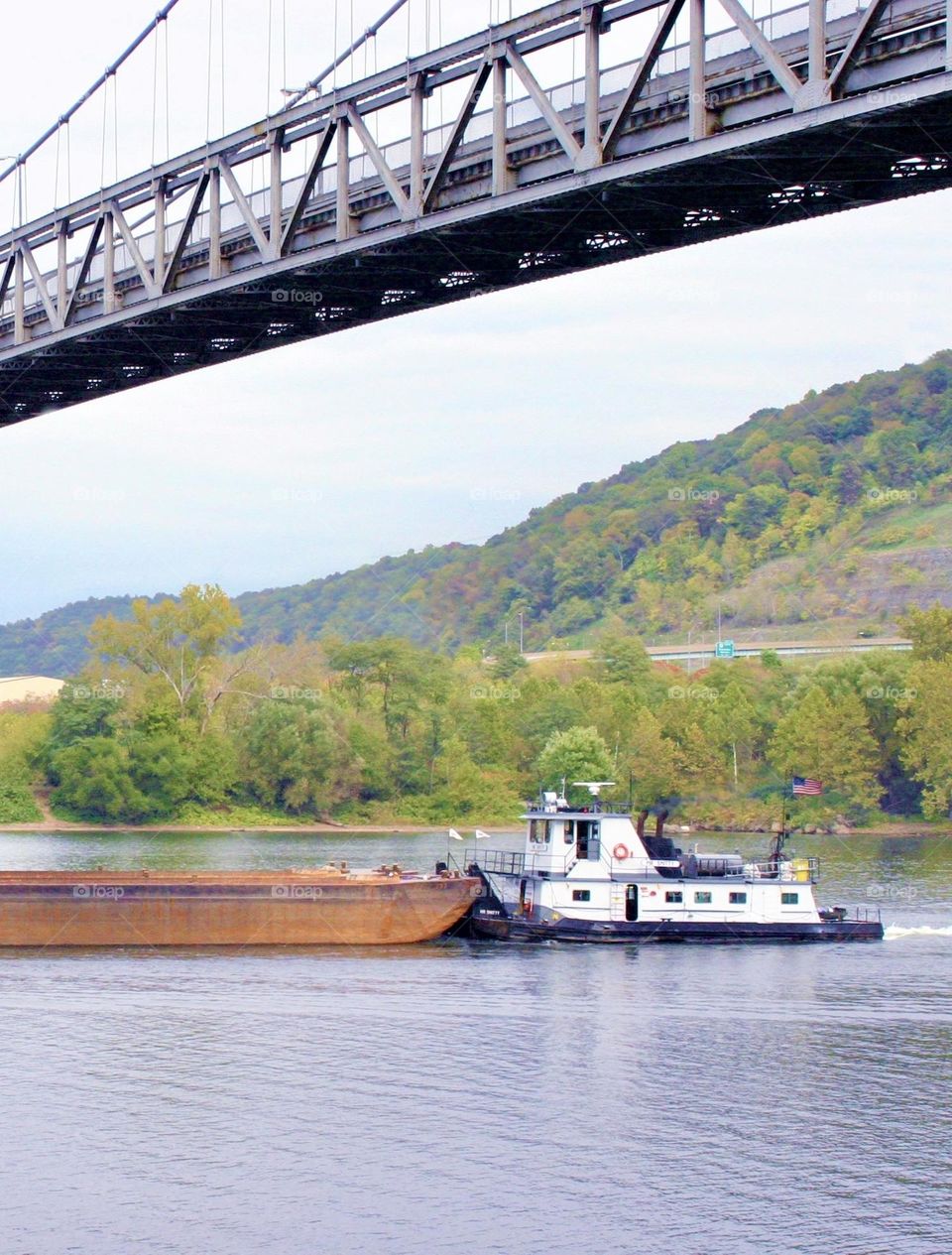 Triangle pattern on bridge, barge on the river