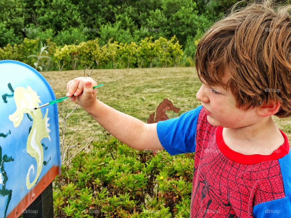 Childhood Art Project. Young Boy Painting A Mailbox
