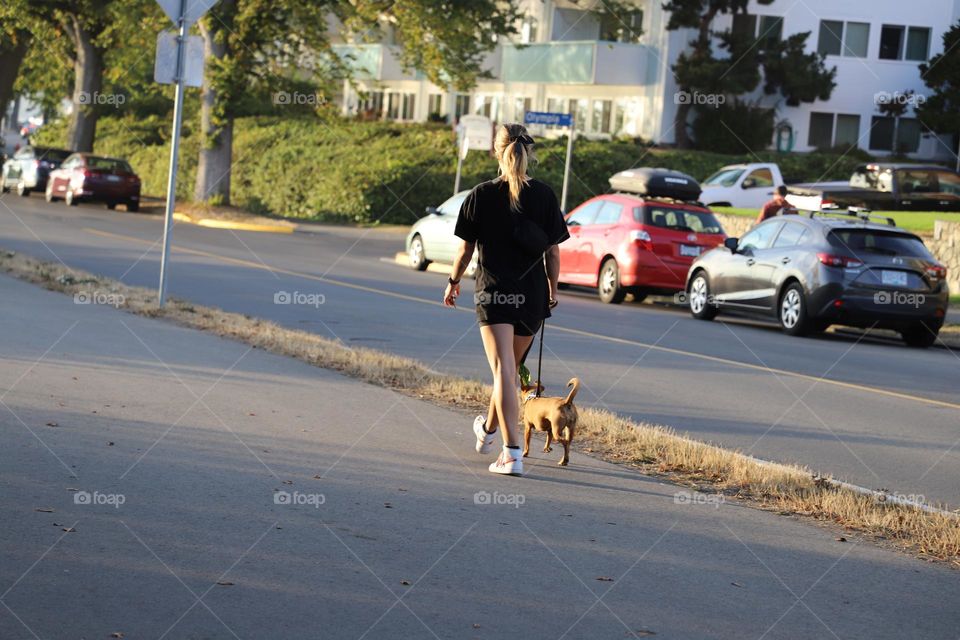 Woman and dog walking on the street