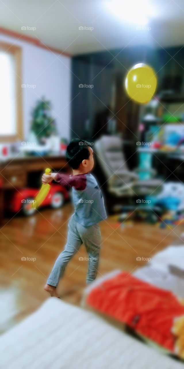 hitting the balloon while its flying  instead of a ball.