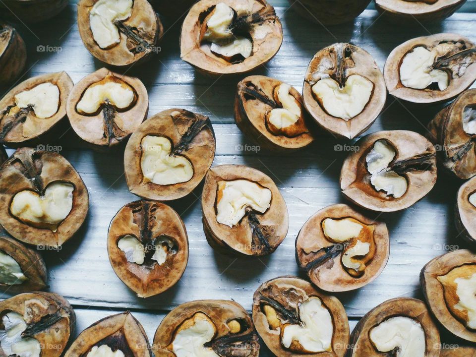 halves of walnuts on a white background