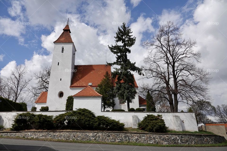 Church of the Nativity of St. John the Baptist, built in Romanesque style with a Baroque extension. In the village of Hovorcovice near Prague.