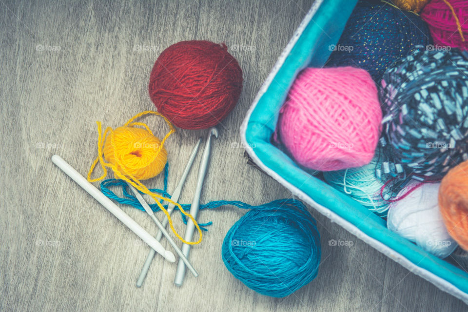 Crochet needle and wool on table