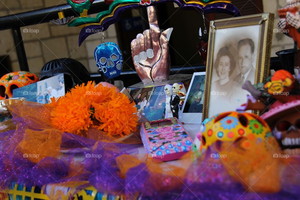 Descendants display altars to celebrate and remember the dead at San Antonio's Día de lots Muertos festival. Shown here is a table remembering a father and mother who passed, and items that help keep their memory alive 