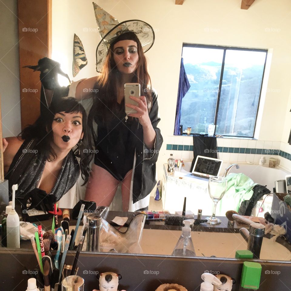Two woman in black costume with gothic makeup