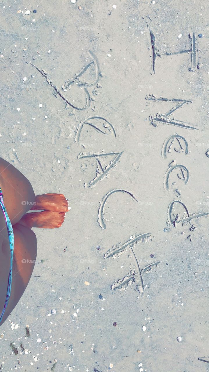 I need beach...all Day, every day. Handwritten in sand. Tanned and beachy with bikini and white toes. 