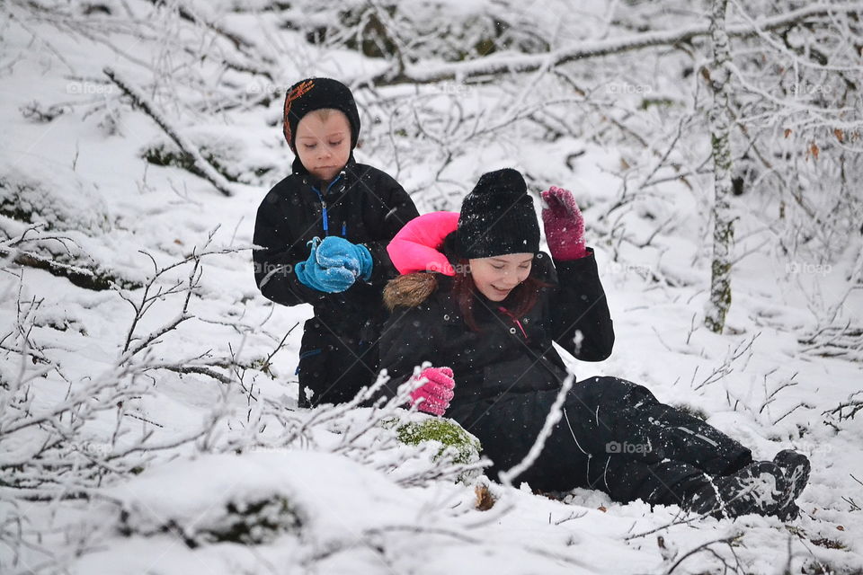 Two children in a snowball fight