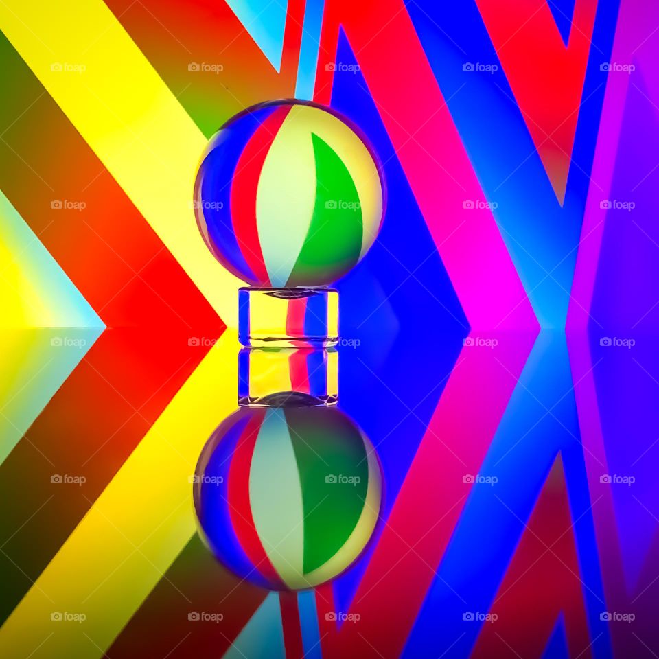 Colourful pattern reflected in lens ball and mirrored