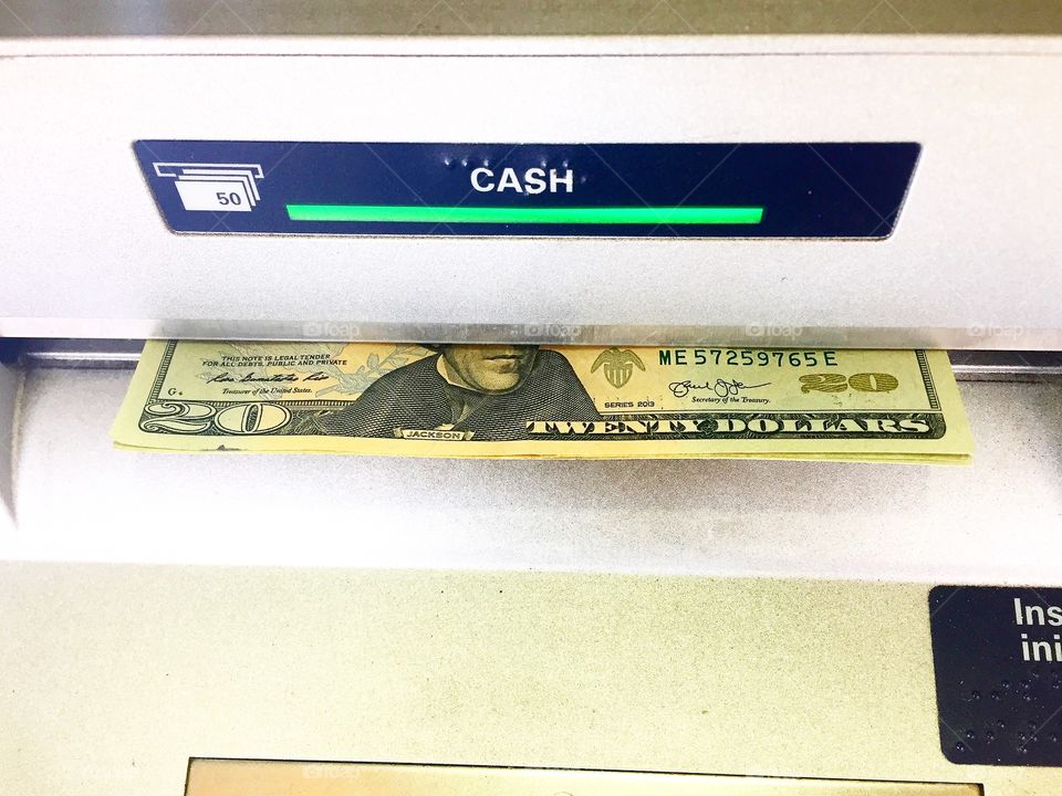 Cash being dispensed from an ATM
