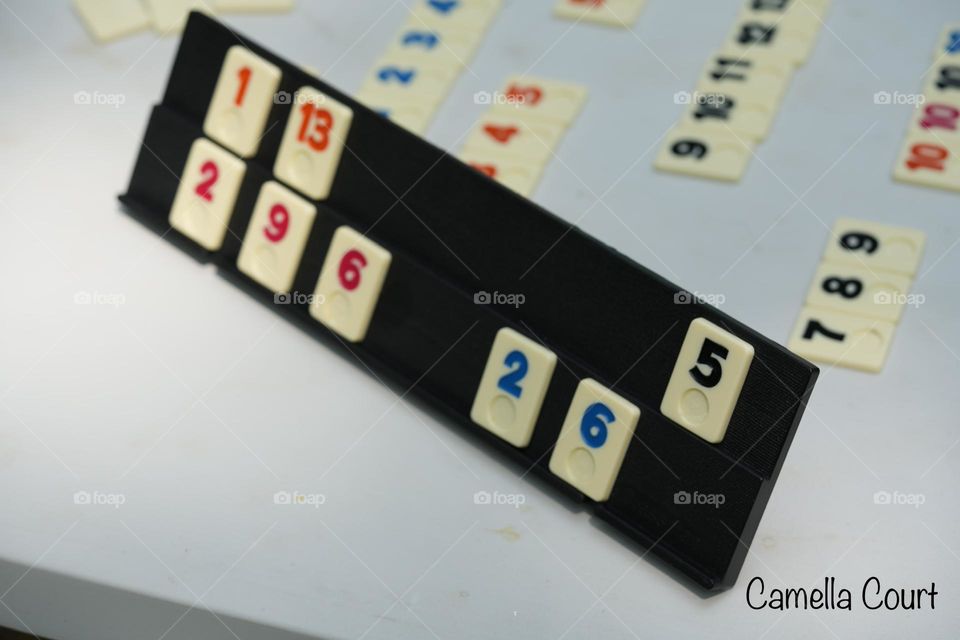 Playing rummicube with family on vacation on a fold out table