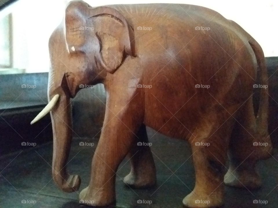 carved wooden elephant on an antique wooden sideboard