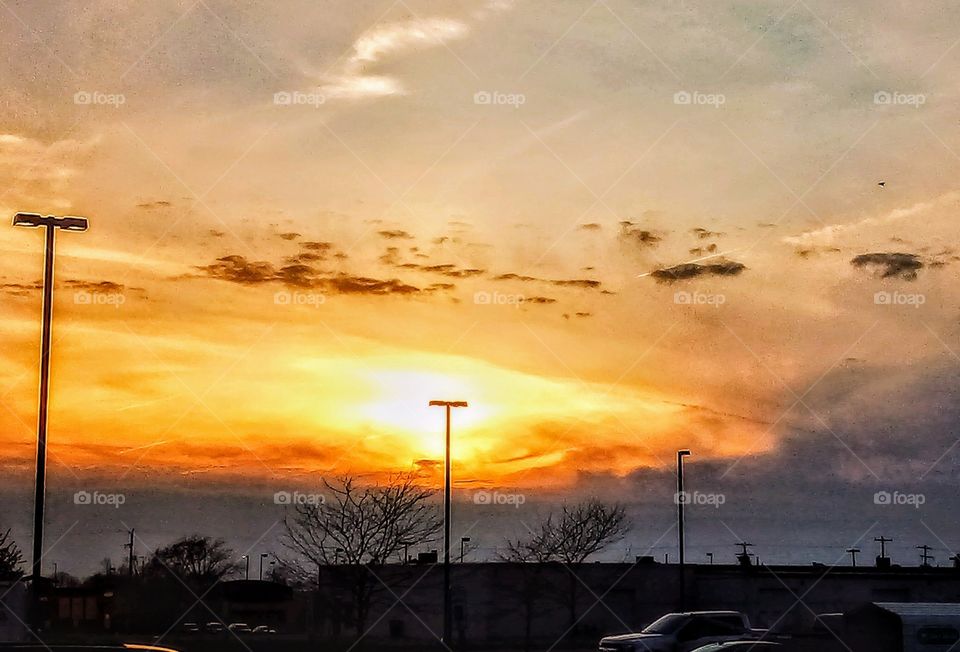 orange sky in the evening over a parking lot