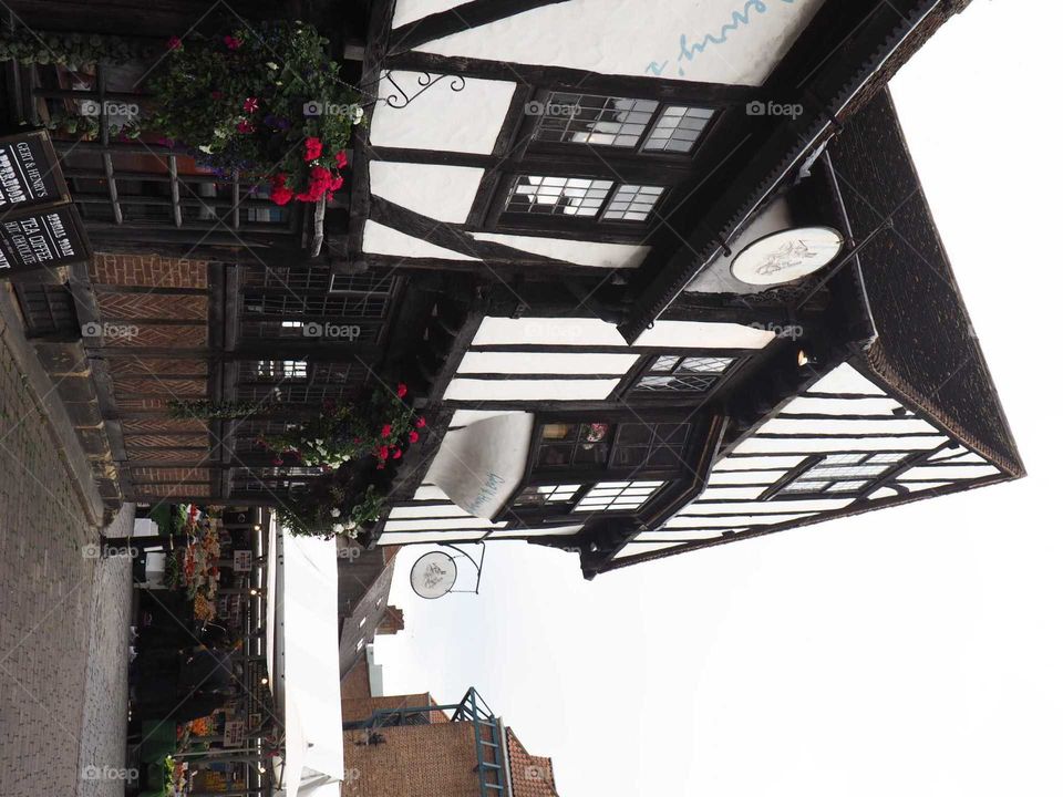 Beautiful, traditional pub house in York, England with bright colours and flowers in front