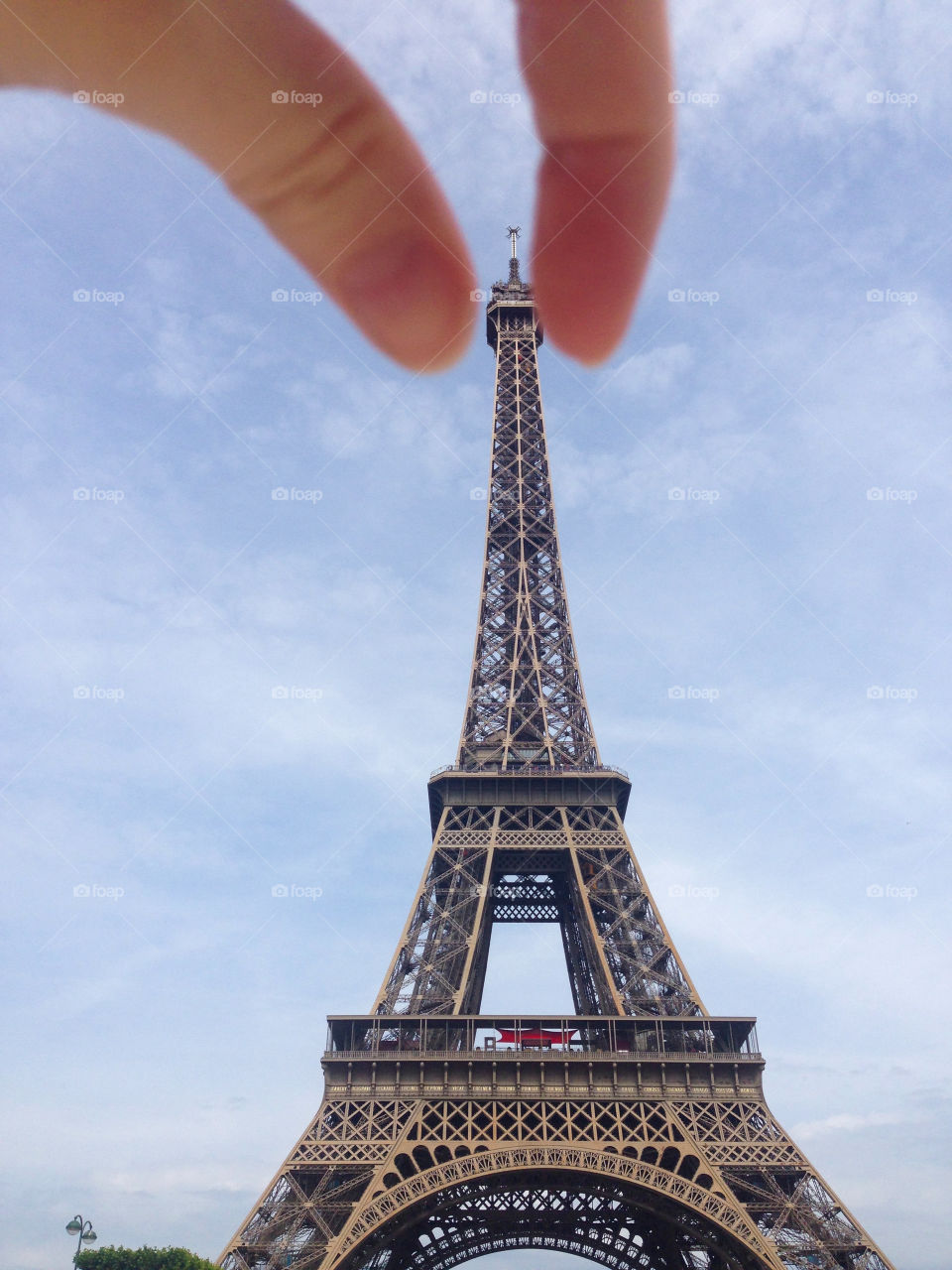 Person's hand grabbing the tower