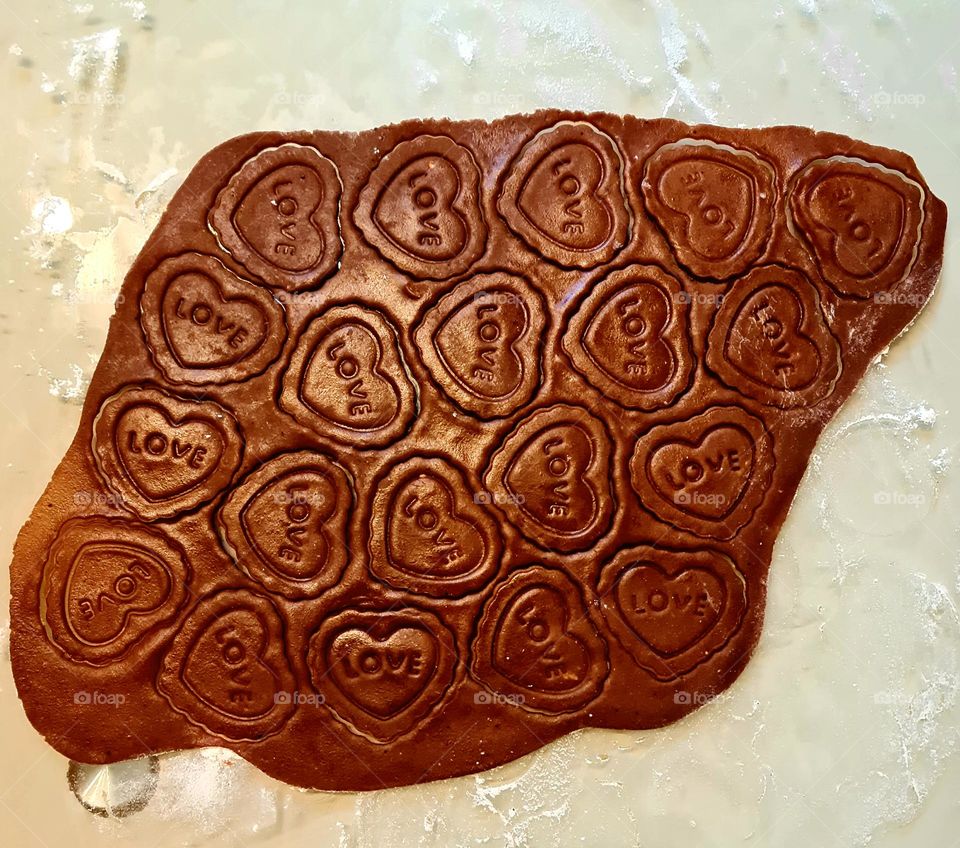 brown gingerbread dough, heart shapes with the word love