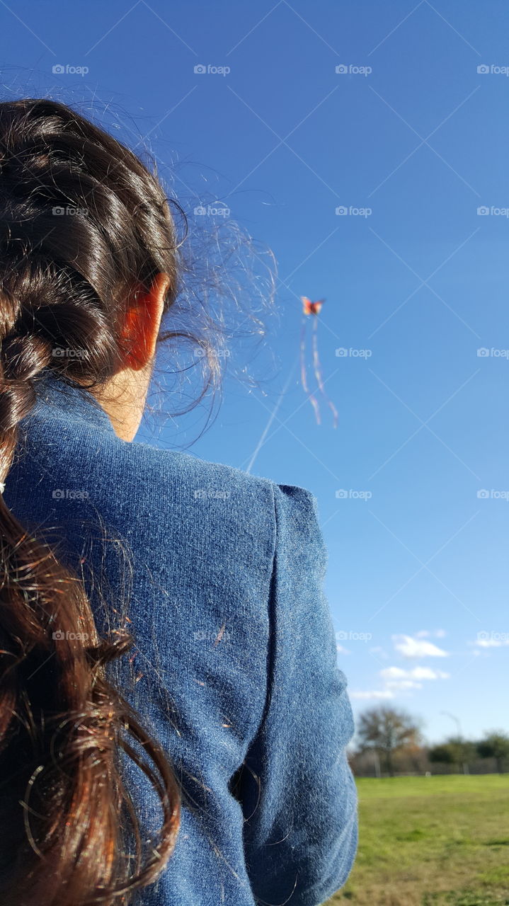 Girl flying kite