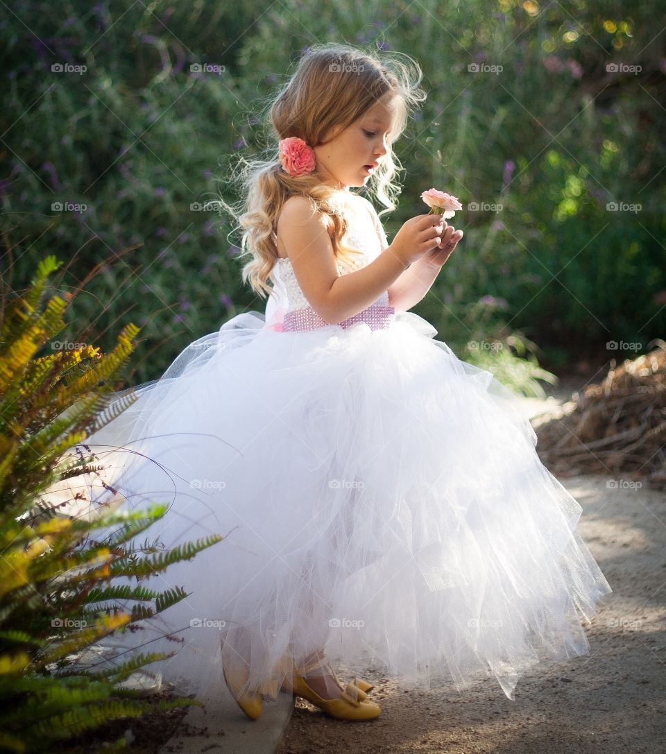 Cute girl holding flower in hand