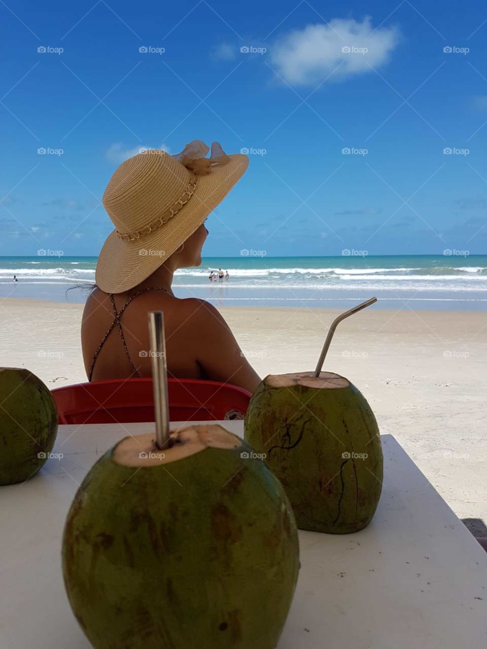 A coconut, a reusable straw, the sea and nothing else.