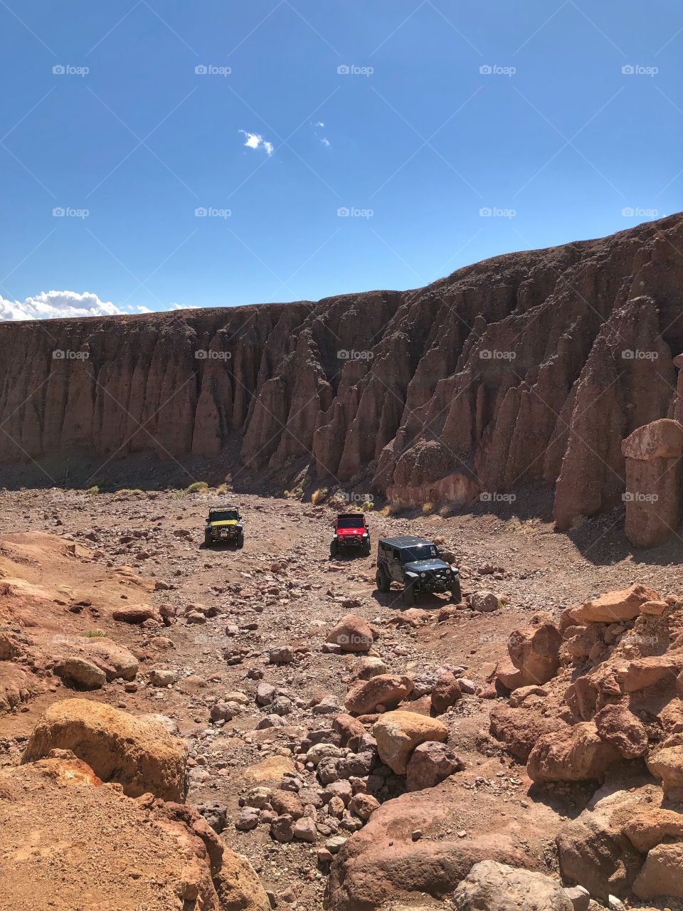 Jeeps in a deep canyon, large rock walls
