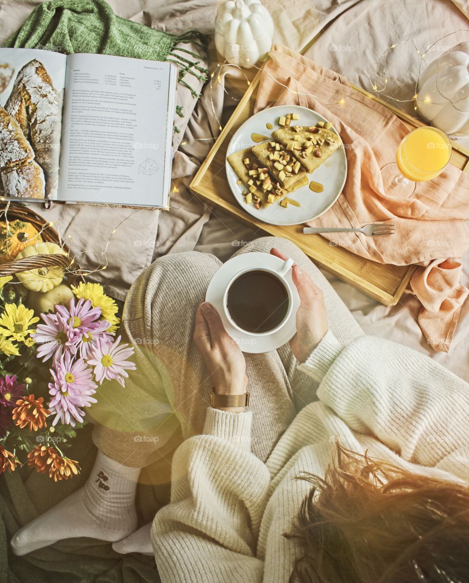 Girl drinking coffee, breakfast in bed