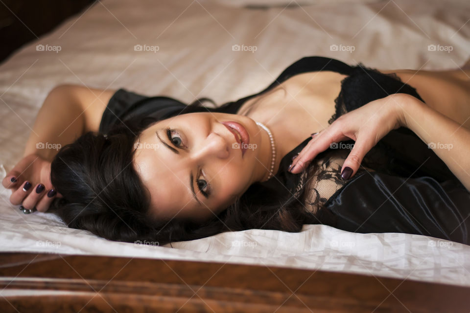 Young woman lying on bed