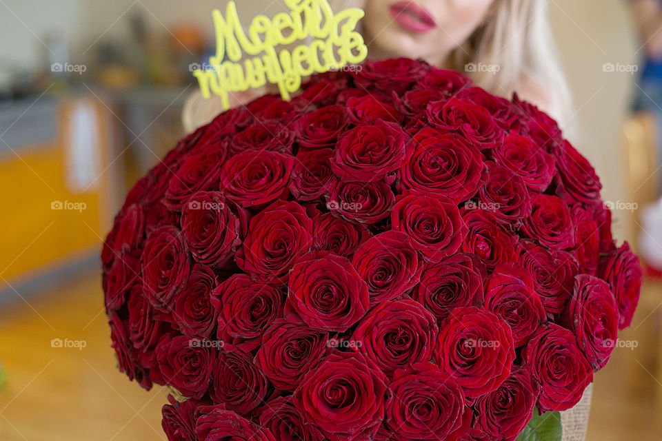 girl with a large bouquet of roses