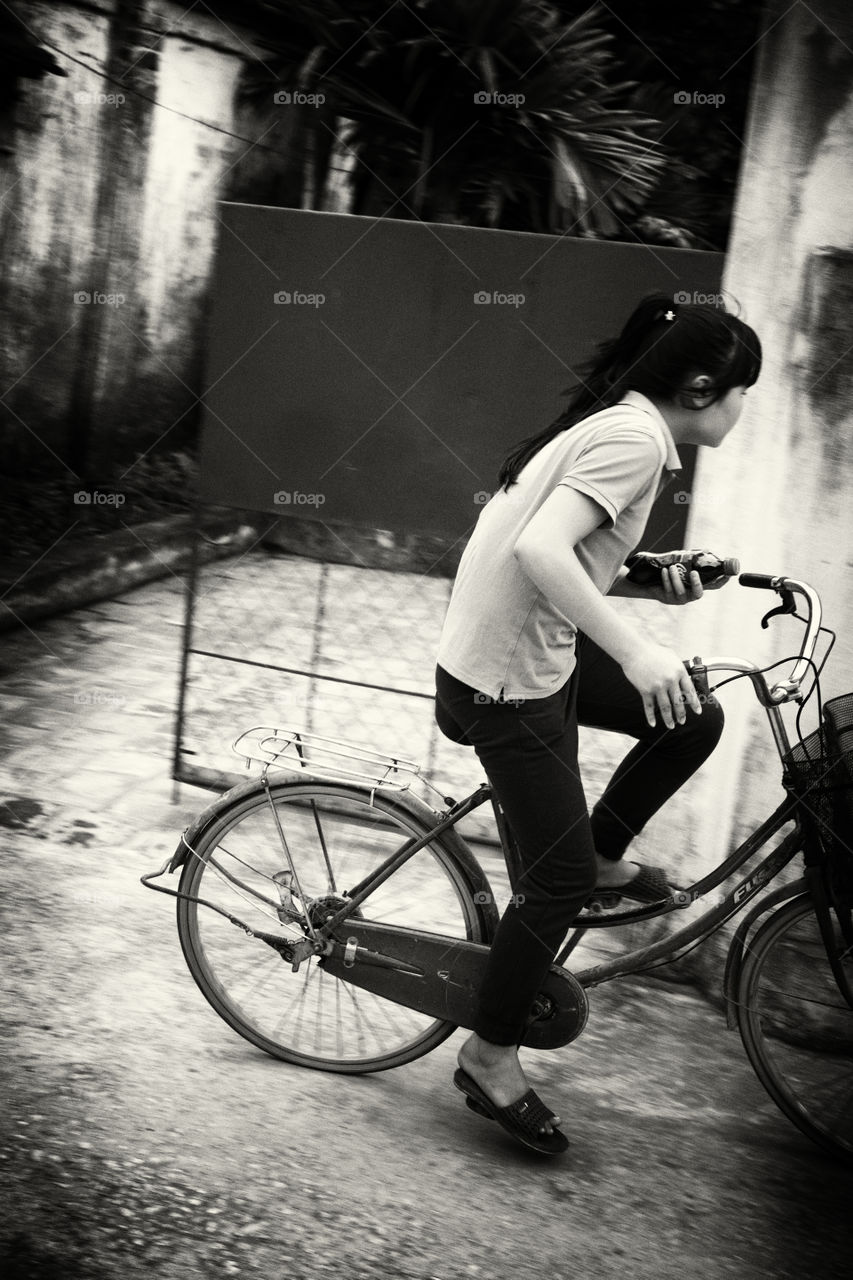 Girl cycling in Vietnamese village (Thanh Hoa)