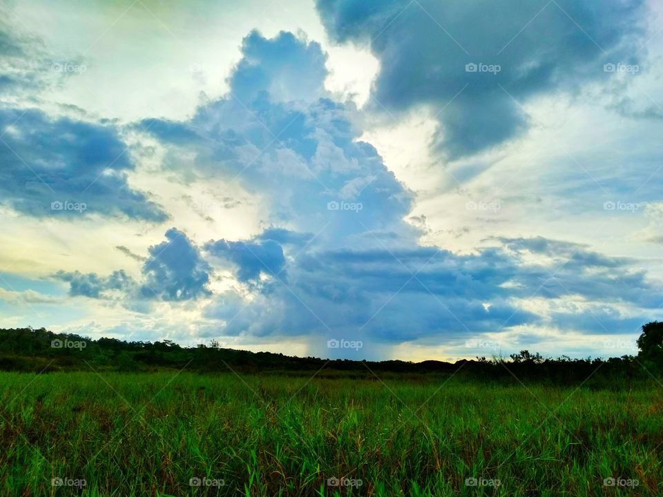 Stormy clouds over the green pasture