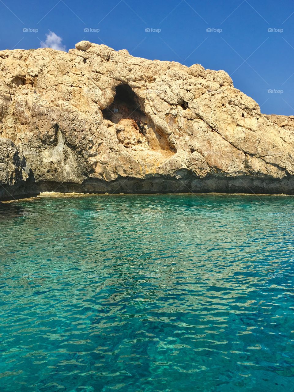 View of cliff and turquoised sea water