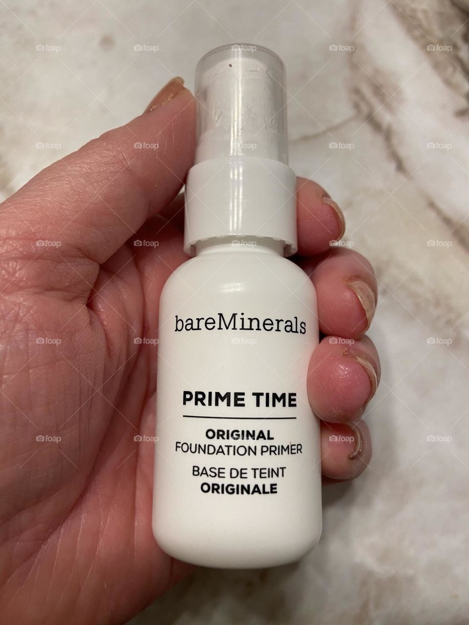 My hand holding Prime Time Original Foundation Primer from Bare Minerals. This product is the perfect base layer to use with Bare Minerals Original Foundation. It is light and you don’t need to use a lot. 