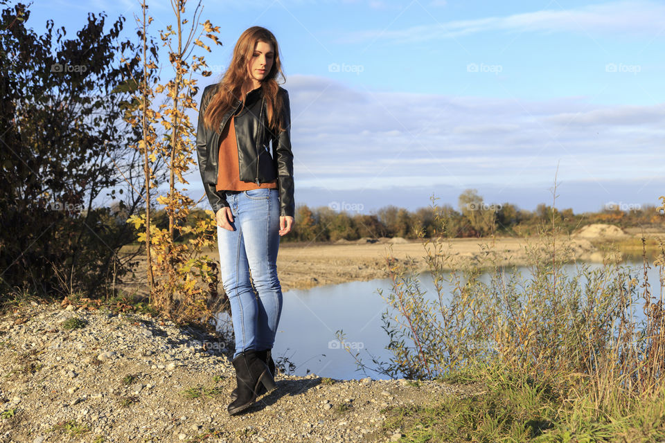 Woman standing in front of lake